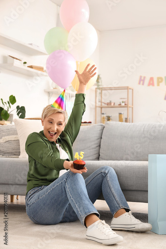 Happy mature woman with bir...