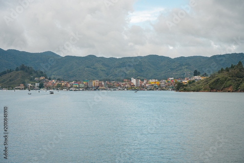 Guatapé village by reservoir in colombia with green mountains