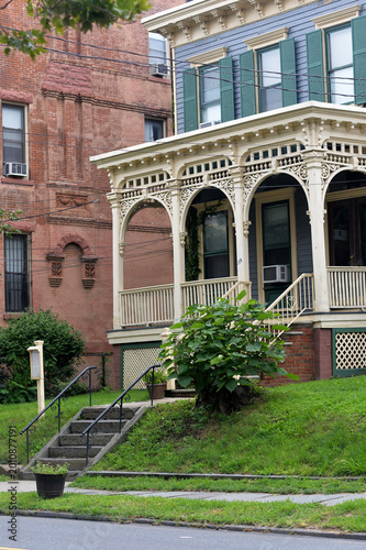 Фотография Classic Urban Residence Showcasing Decorative Iron Balustrades And Lush Plants n
