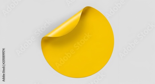 Yellow sticker with curled corner on gray background