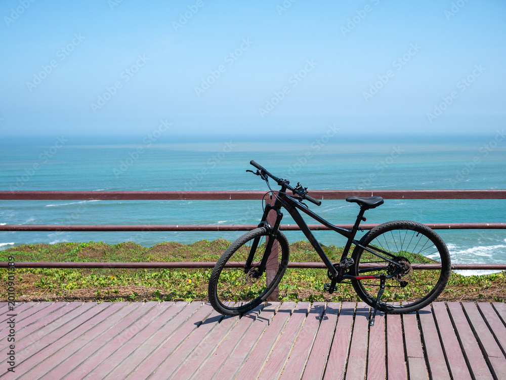 Fototapeta premium Mountain Bike by the Ocean Boardwalk
