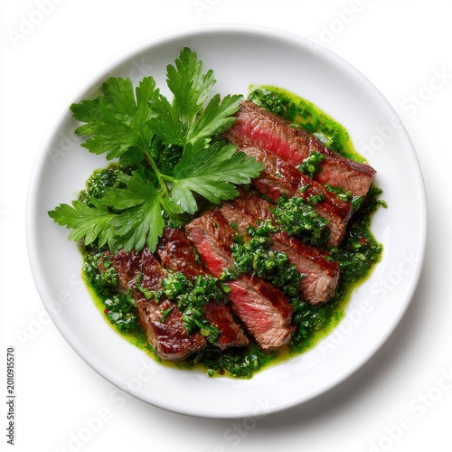 Chimichurri sauce with grilled steak slices and fresh parsley isolated on a white background