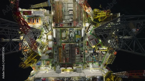 Aerial top view of offshore jack up rig and offshore platform during sunset for oil and gas exploration and production. 