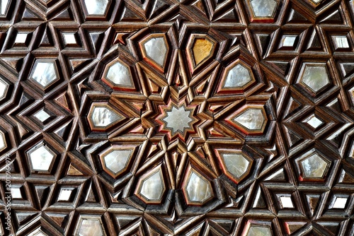 Fotografie Mother-of-pearl inlaid wooden door decoration consisting of complex geometric and symmetrical motifs