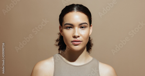 Bilde på lerret Portrait, skincare and woman in studio, glow and natural dermatology on brown background space