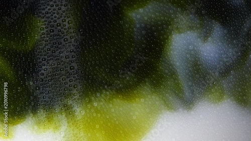 4K stunning macro shot concentrated green tea matcha swirling into fresh milk inside glass with condensation, Marbling effect of matcha latte refreshment healthy beverage trends.