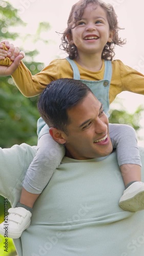 Outdoor, father and girl on shoulder, happiness and bonding together with holiday, care and funny. Bokeh, dad and daughter with game, flying and playing with growth development, child and humor