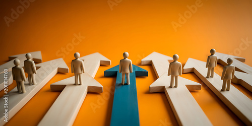 Business people standing on arrows pointing in different directions on orange background