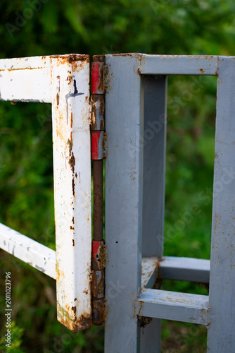 Картината върху платно a rusty metal hinge on a crossbar that is starting to corrode