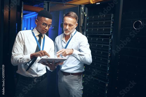 Картината върху платно Planning, engineer or men with tablet in server room, system backup schedule or cybersecurity update