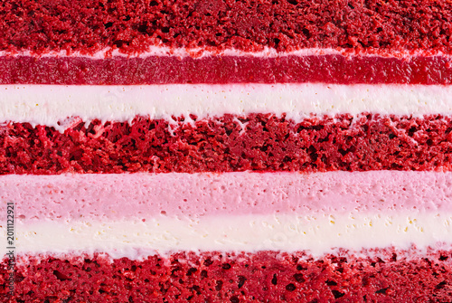 Layers of red velvet cake with cream filling displayed in close-up