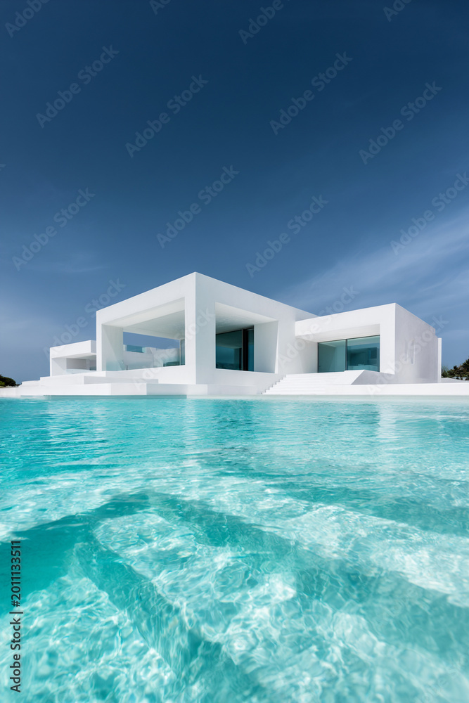 Fototapeta premium modern minimalist white villa with pool, luxury geometric white house with turquoise pool, contemporary mediterranean villa with clean lines and terrace