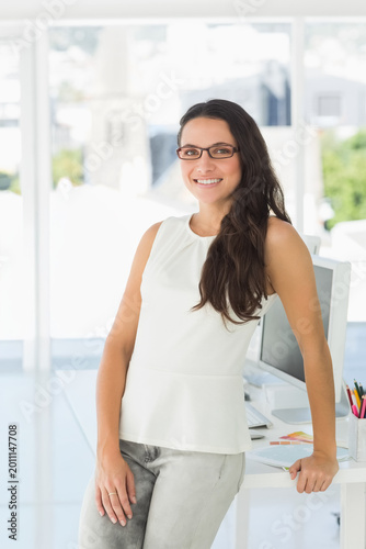 Female leaning at desk in office, wearing peplum top and eyeglasses holding color swatches Free Download Female leaning at desk in office, wearing peplum top and eyeglasses holding color swatches - GFXLoad