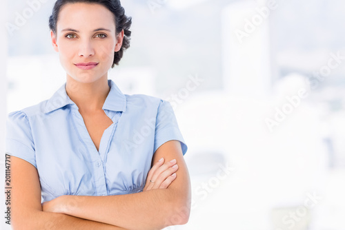 Adult woman standing with arms crossed, wearing light blue blouse at office, showing ring Free Download Adult woman standing with arms crossed, wearing light blue blouse at office, showing ring - GFXLoad