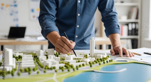 Architect Working on a Detailed Architectural Model of a Modern Cityscape