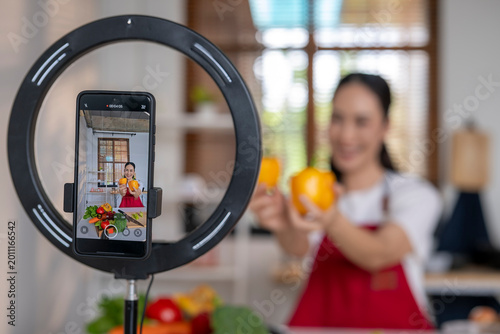 Woman food blogger recording cooking video with smartphone