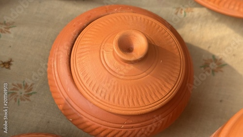 Schilderij op canvas Handcrafted earthenware pot with a decorative lid showcasing traditional pottery