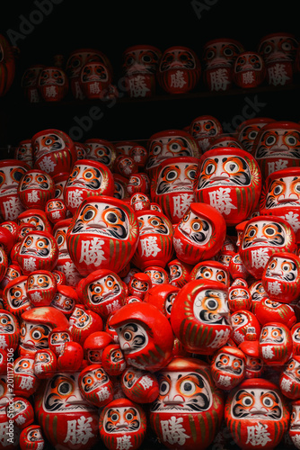 Collection of red Japanese Daruma dolls with Kanji character for Victory and Success