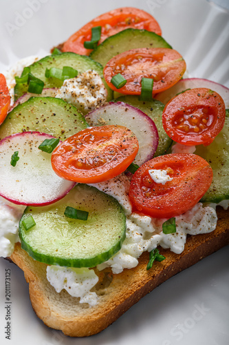 Vegetable toast with cucumber tomato radish and cottage cheese. Healthy homemade breakfast and vegetarian snack concept.