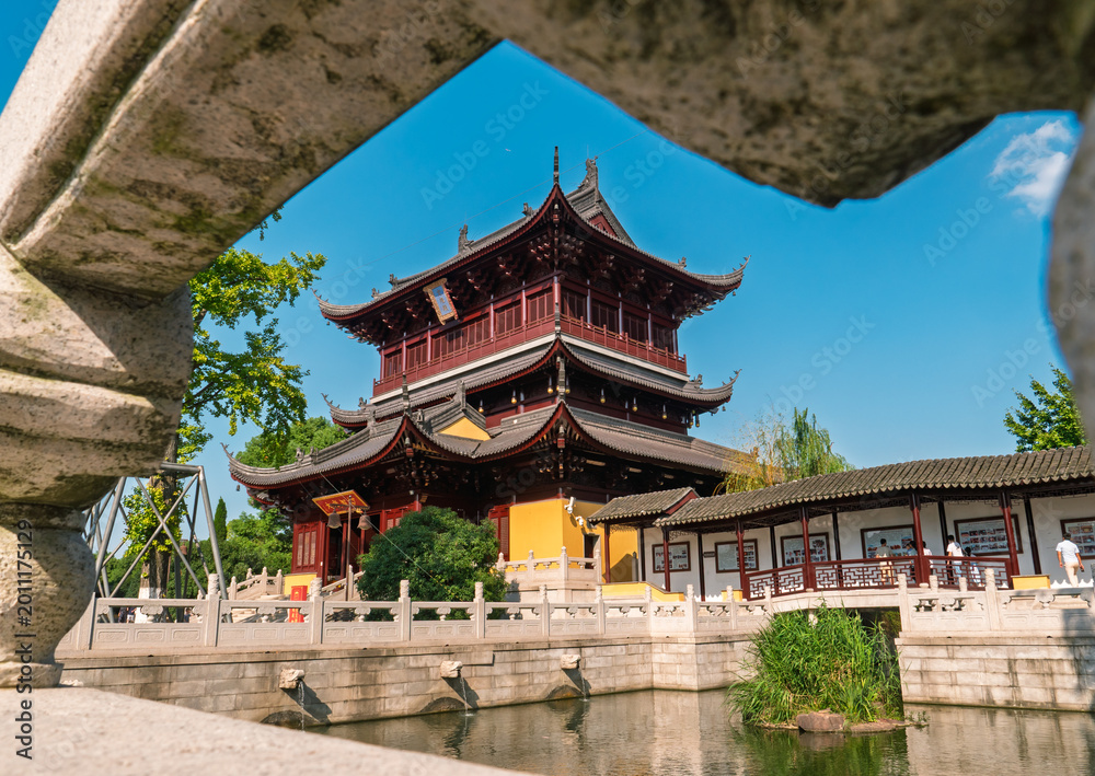 Fototapeta premium Ornate Chinese temple building and corridor over calm water