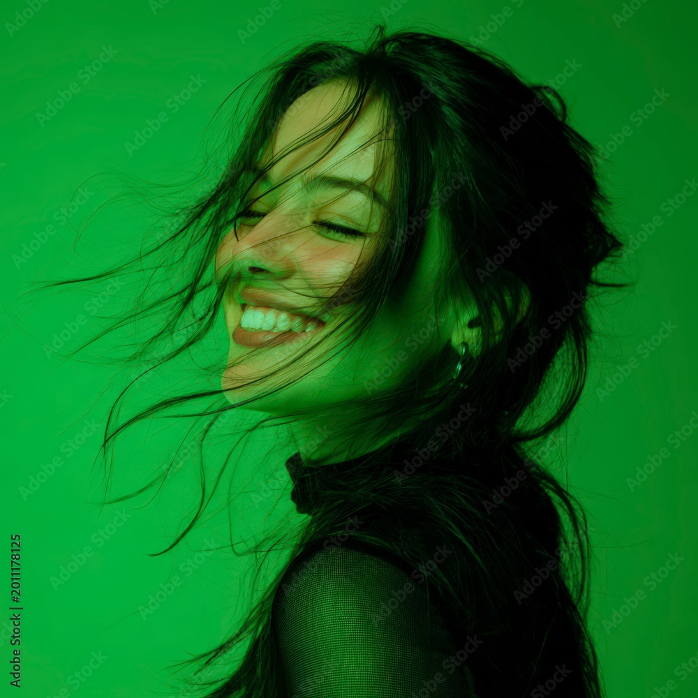 Naklejka premium Woman laughing with hair blowing in the wind