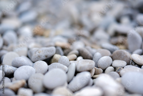 Photography Soft blurred background focusing on smooth light grey beach pebbles