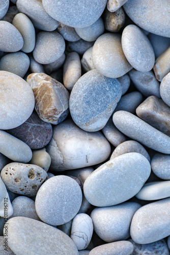 Canvas Print Vertical natural pattern created by smooth dry grey and light blue pebbles