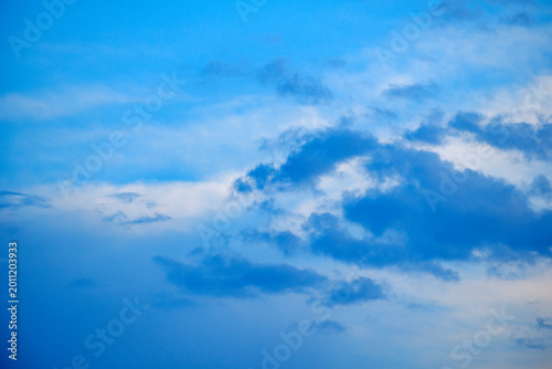 Tablou pe pânză Soft wispy cloud layers drifting across a serene pure blue sky