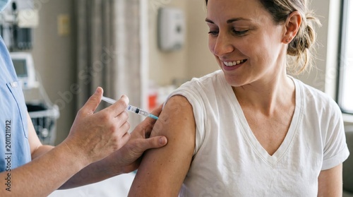 Healthcare worker nurse giving vaccine injection to adult woman patient in clinic for medical immunization and prevention