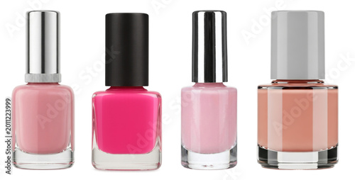 Four bottles of colorful nail polish in various pink and nude shades, isolated on a transparent background.
