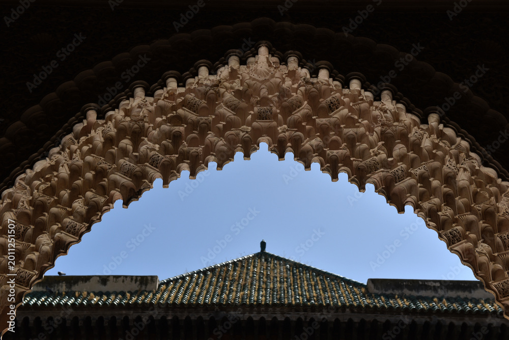 Naklejka premium Carved stone gate arch, carved wooden architectural details, Medersa bou Inania, Fez, Morocco