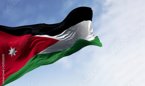 Jordan national flag waving in the wind. Black, white, and green horizontal stripes with a red chevron on the left housing a white seven-pointed star. 3d illustration render.