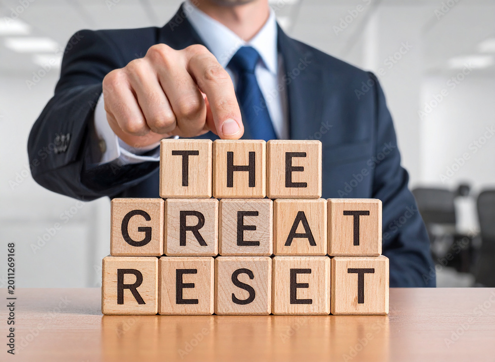 Fototapeta premium The great reset - Geschäftsmann zeigt auf den Text 