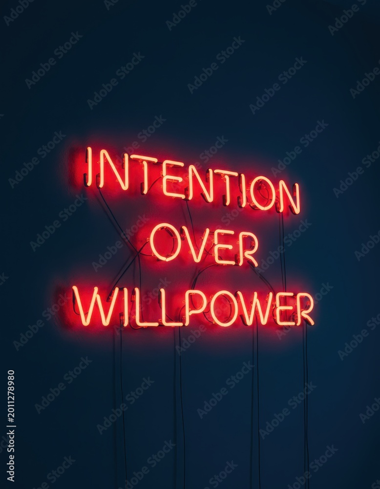 Obraz premium Red neon sign glowing on a dark wall with the message 