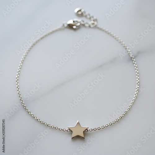 Delicate Silver Star Charm Bracelet Arranged on White Marble Surface