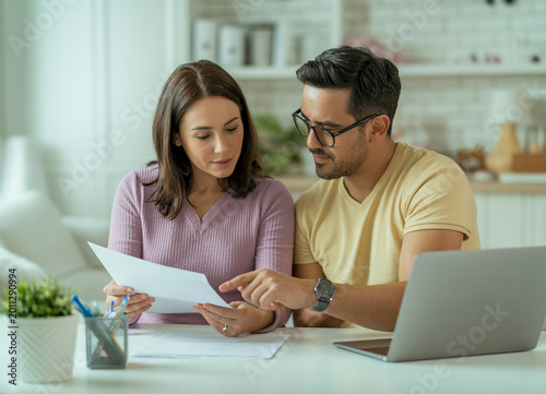 The couple reviewed healthcare documents together at home.