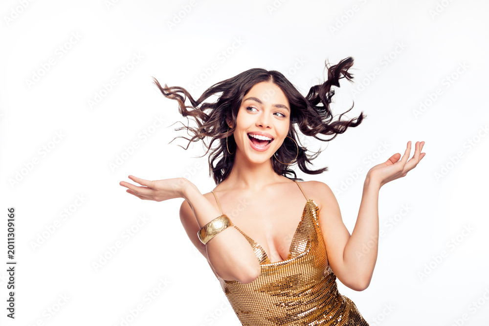 Fototapeta premium Joyful young woman in a gold sequin dress celebrating with windblown hair — glamorous party fashion portrait showing confidence, fun and festive energy