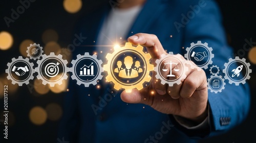 Businessman holding a glowing gear with a human icon, representing human resources, management, and corporate leadership in a digital business environment