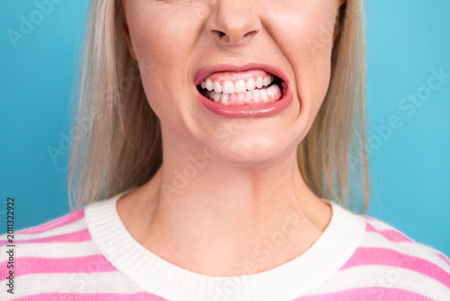 Φωτογραφία Close-up of woman clenching teeth in tense grimace showing jaw strain and dental