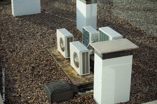 The external units of the commercial air conditioning and ventilation systems are installed on the roof of an industrial building