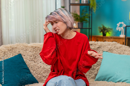 Foto Young woman making facepalm gesture at home, clearly demonstrating tiredness, frustration and irritation