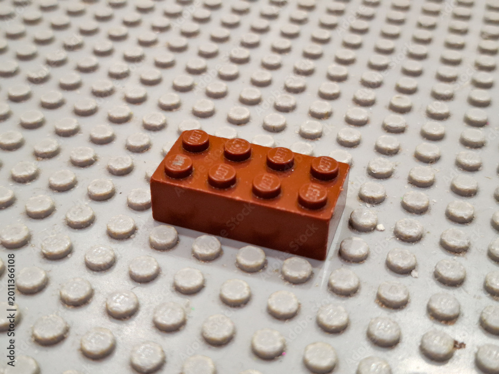 Fototapeta premium ingle Brown Plastic Lego Brick Placed on a Gray Baseplate as Illustrative Editorial for Creative Building and Educational Construction Hobby on December 19, 2025 in Bangkok, Thailand 