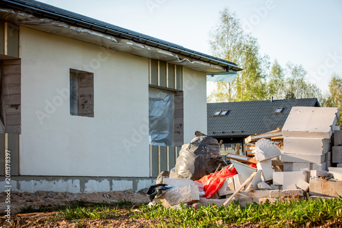Bild auf Leinwand Construction Waste Pile Near House Exterior During Building and Renovation Work