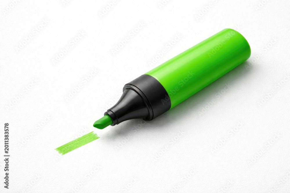 Fototapeta premium Bright green highlighter isolated on a plain white texture with copy space