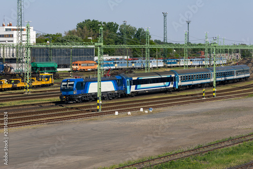 Fotografía Blue passenger train in railway yard