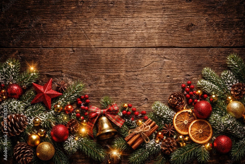 Naklejka premium Traditional holiday decorations set against a rough worn wood panel providing copy space
