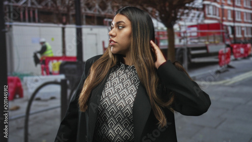 Fotografi Plus size woman raises hand palm out in stop gesture, frowning with nose ring and patterned blouse on a city street near construction barriers; frustration boundary