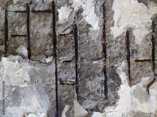 Concrete surface is peeling and the steel reinforcement is visible.
