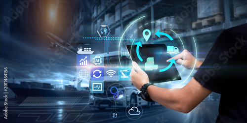 Business Logistics technology concept.Man hands using tablet on blurred warehouse as background
