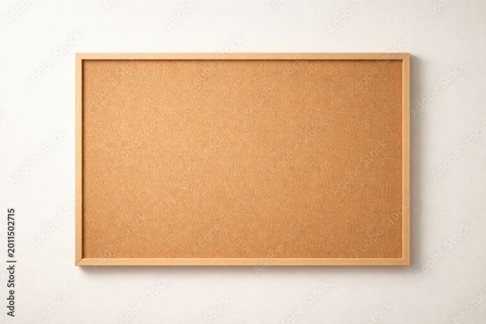 Fototapeta premium Minimal light backdrop displaying an empty wooden cork board with generous copy space